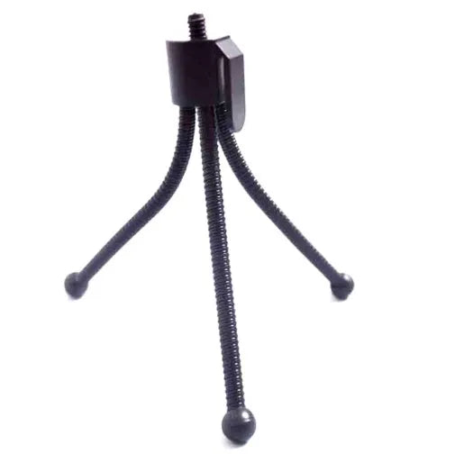 Compact silver metal mini tripod with ball head, shown folded next to an iPhone for scale.