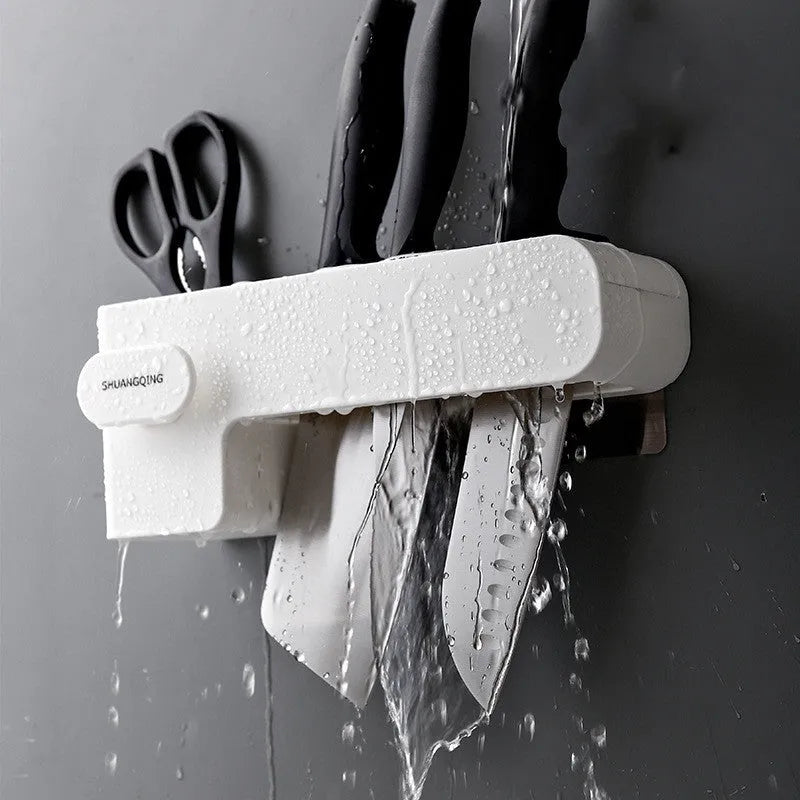 White plastic kitchen knife rack mounted on wall with dimensions 10.6 cm wide by 26 cm tall