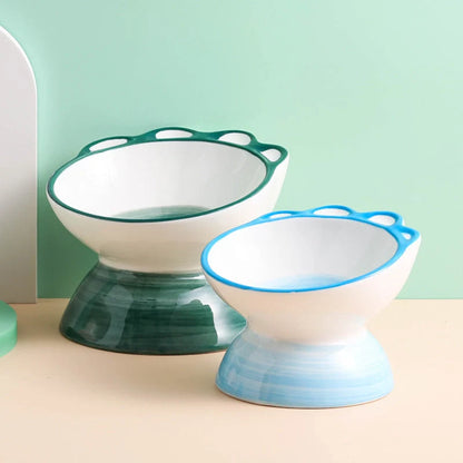 Ceramic pet bowl with cartoon paw design and 15-degree incline for comfortable feeding