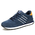Men's blue pigskin leather sneakers with flat heel and rubber sole on grey background