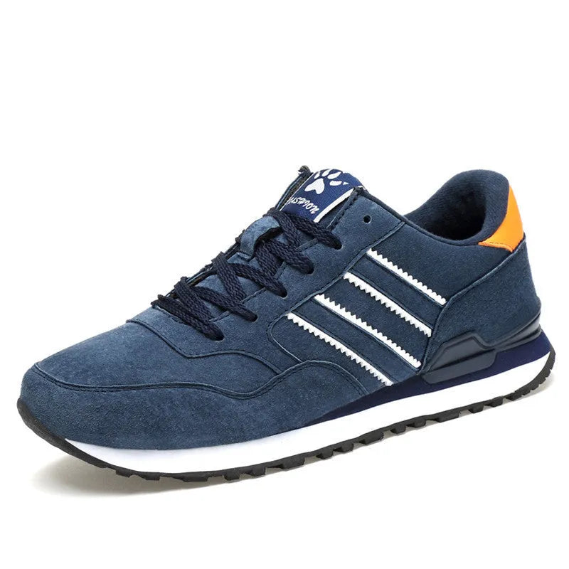 Men's blue pigskin leather sneakers with flat heel and rubber sole on grey background