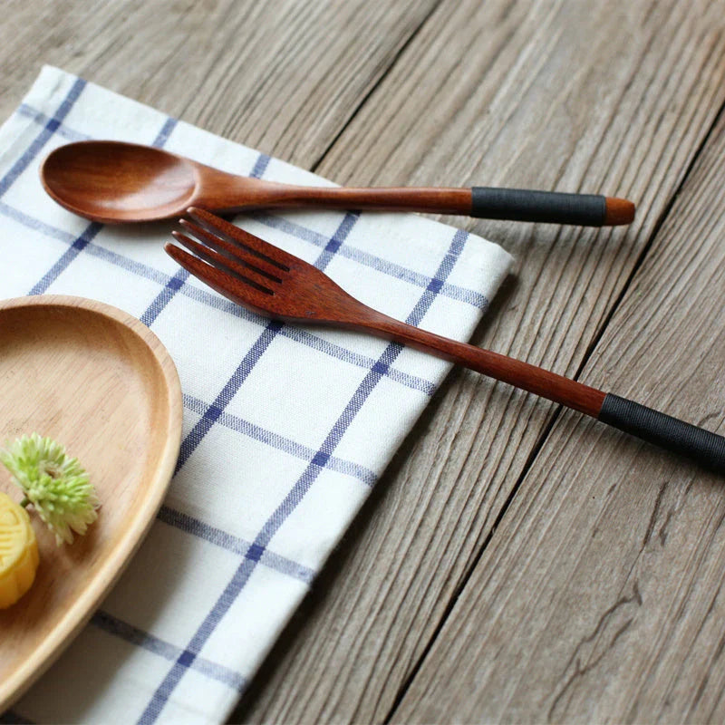 Japanese-style wooden bamboo spoon and fork set on a wooden table