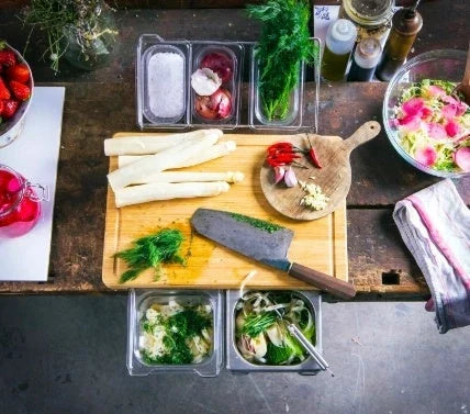 Versatile bamboo cutting board with integrated storage trays for organized meal prep