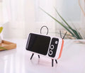 Retro TV mini portable Bluetooth speaker in blue with circular grille and compact 18x8x2.5cm size on a wooden desk