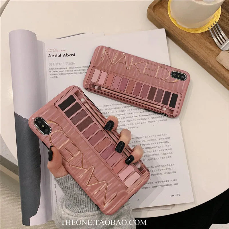 Flesh and grey silicone phone case for various iPhone models on a table.