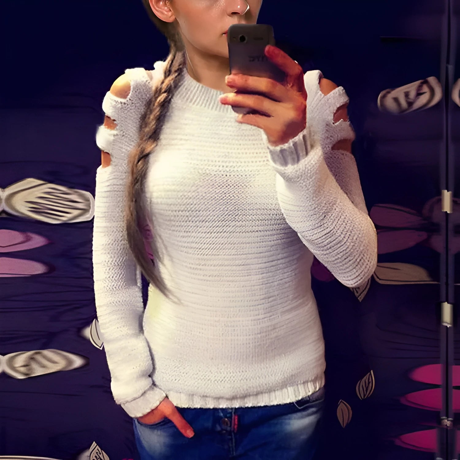 Women's grey hollow-out crocheted knitted long-sleeve shirt with round neck on a hanger.