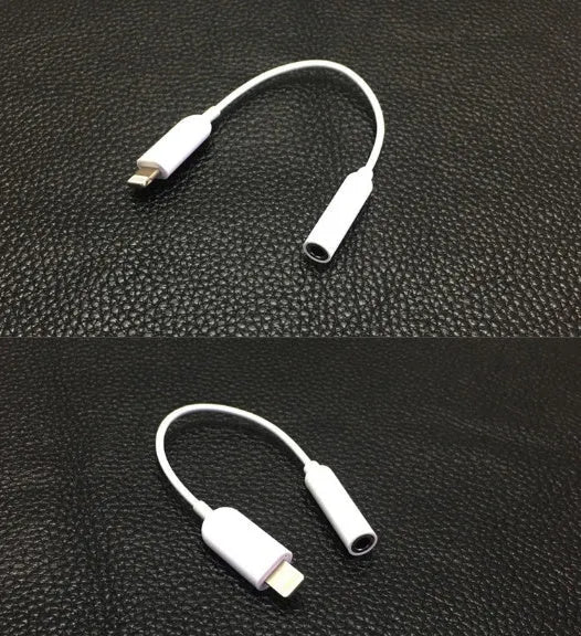 White Lightning to 3.5mm audio adapter cable on a dark background, showing both connectors.