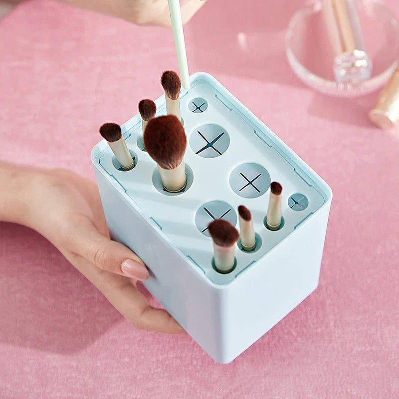 Inverted makeup brush storage bucket in white, blue, and pink for organised dressing tables