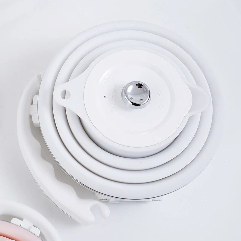 Foldable electric kettle in white, blue, and pink with UK, US, and EU plugs