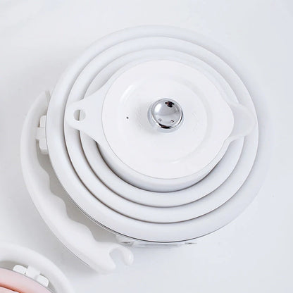 Foldable electric kettle in white, blue, and pink with UK, US, and EU plugs