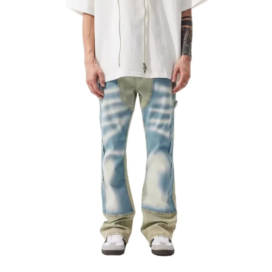 Yellow and blue retro patchwork jeans with splash-ink distressed design on a mid-waist trouser cut.