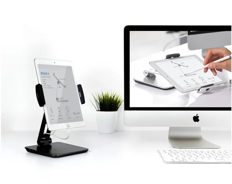 Silver aluminium foldable desktop stand holding a tablet, showing 360-degree rotation.