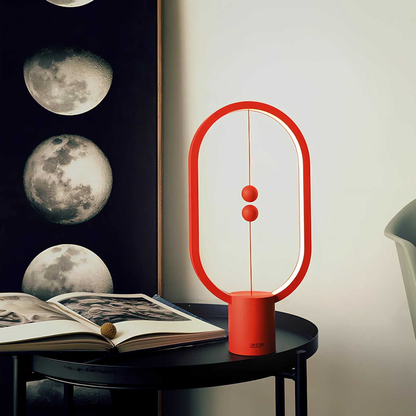 Magnetic bedside night light with ball activation system and adjustable brightness settings