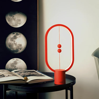 Magnetic bedside night light with ball activation system and adjustable brightness settings