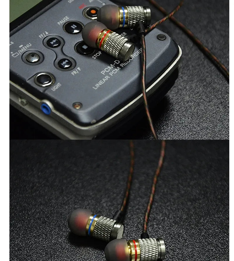 Black wired in-ear headphones with silicone cable, 3.5mm L-bend plug, and TPE ear tips.