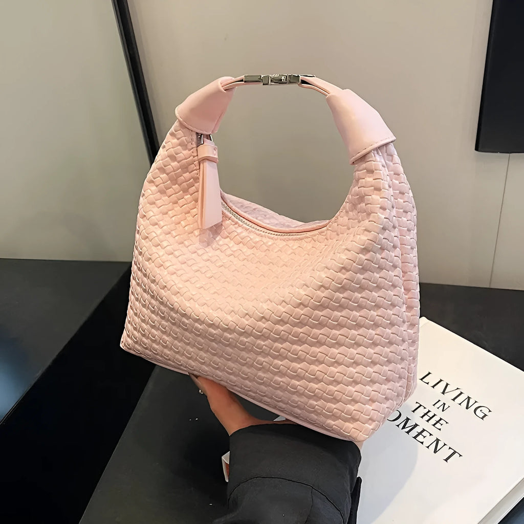 Soft beige PU bucket-shaped messenger bag with an external pocket, shown open to reveal internal document organiser.