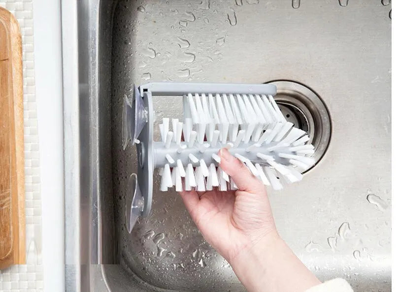 Grey double-headed cup cleaning brush with wall-mounted suction cups for kitchen use