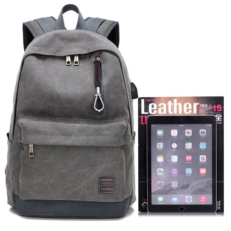 Canvas backpack with USB charging port in grey colour, showing front compartment and shoulder straps.