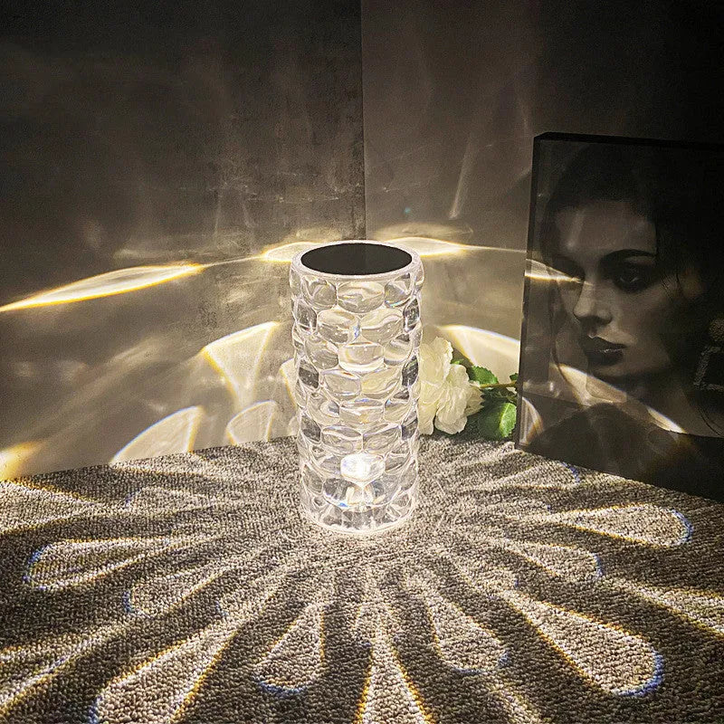 Crystal table lamp with teardrop acrylic shade showing droplet shadow effect on bedside table