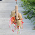 Colourful shredded paper parrot biting toy with wood beads and sisal rope, measuring 15 by 35 cm