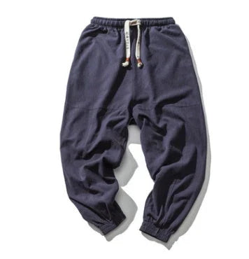 Premium men's streetwear joggers in black, navy, and gray colors with adjustable waistband and pockets