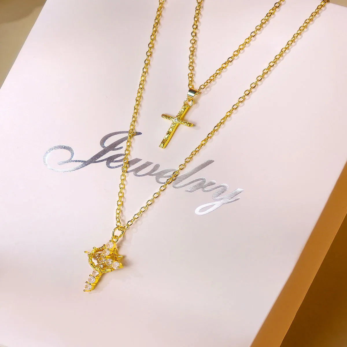 Double layered necklace with letter charm, square cross pendant, and melon seed buckles on adjustable chain