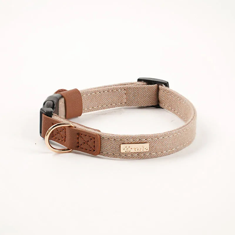 Adjustable mohair dog collar with nameplate and hand holding rope in cement gray