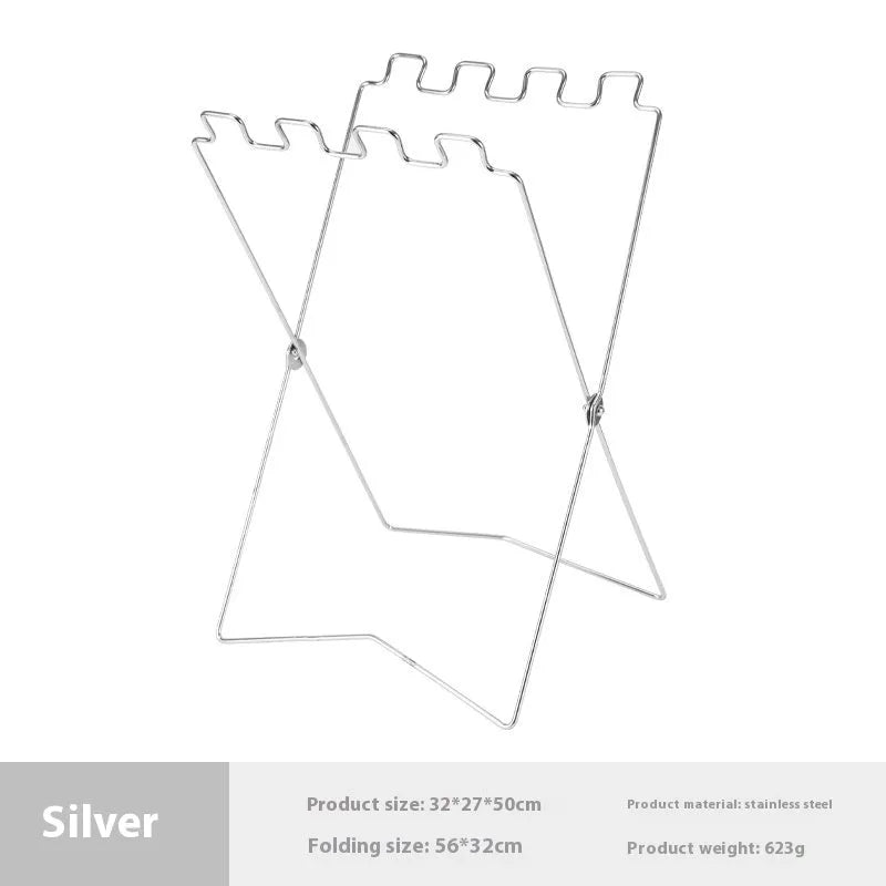 Silver folding stainless steel garbage bag holder bracket on a wooden surface.