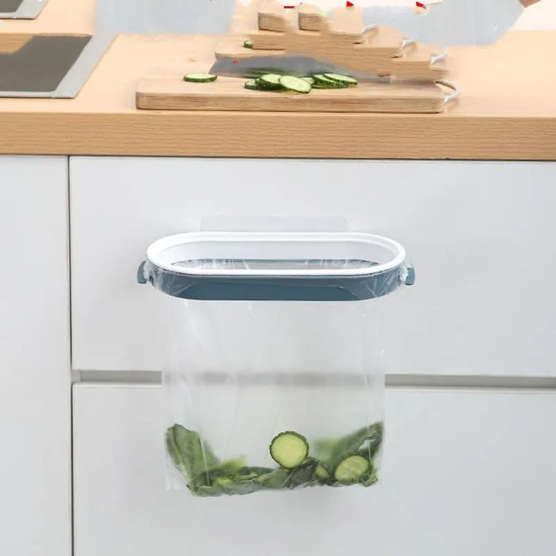 Blue plastic kitchen garbage bag storage rack mounted on a cabinet door.