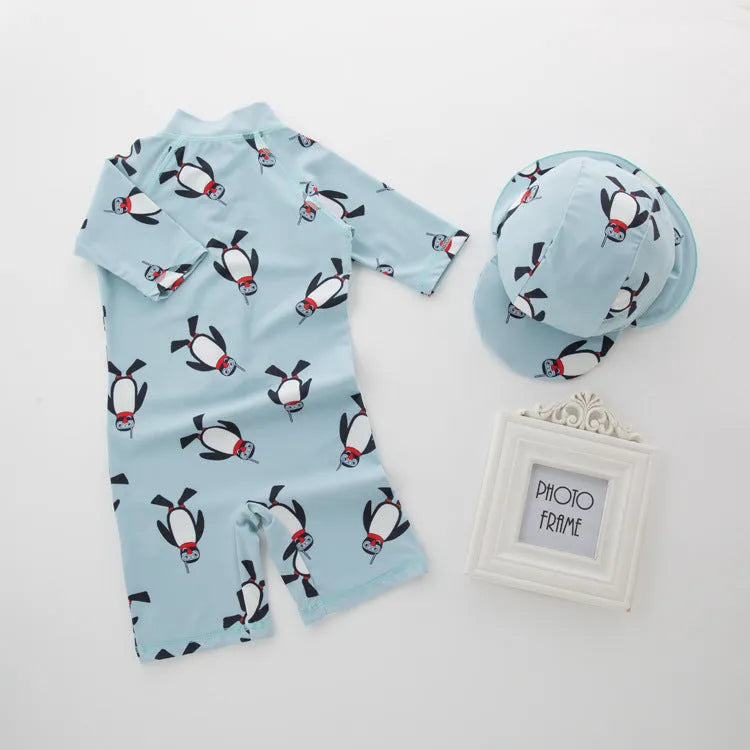 Boys' long sleeve penguin print swimsuit set with matching swim cap for sun protection.