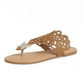 Women's black slip-on sandals with rhinestone decoration and a flip-toe design on a light background.