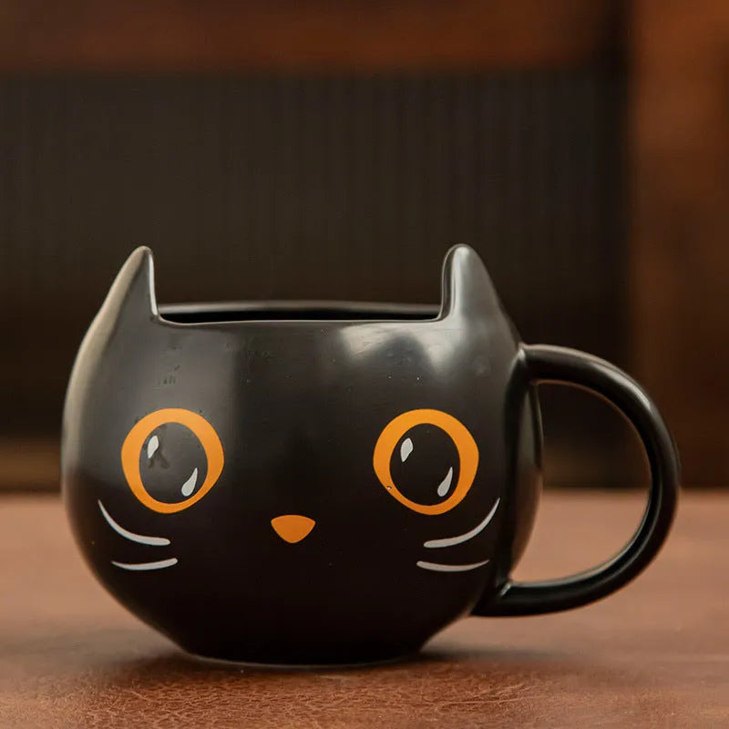 Black ceramic cat-shaped mug with pumpkin spoon couple design, 355ml capacity.