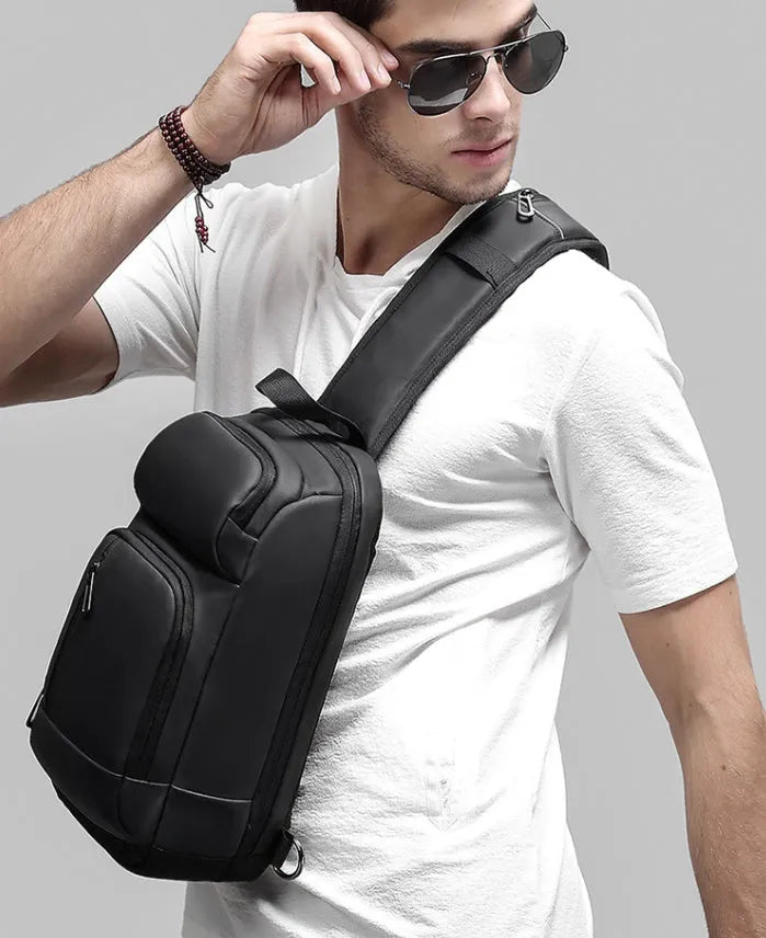 Black PVC outdoor shoulder bag with air cushion strap and internal organisation pockets
