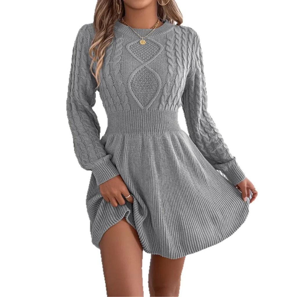 Woman wearing a solid colour acrylic sweater dress with lantern sleeves and an elastic fitted waist.