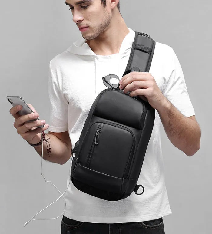 Black PVC outdoor shoulder bag with air cushion strap and internal organisation pockets