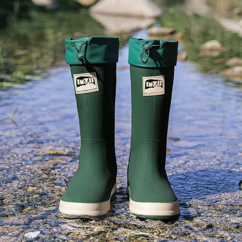 Pair of solid-colour high-tube PVC rain boots with a non-slip sole on a neutral background.