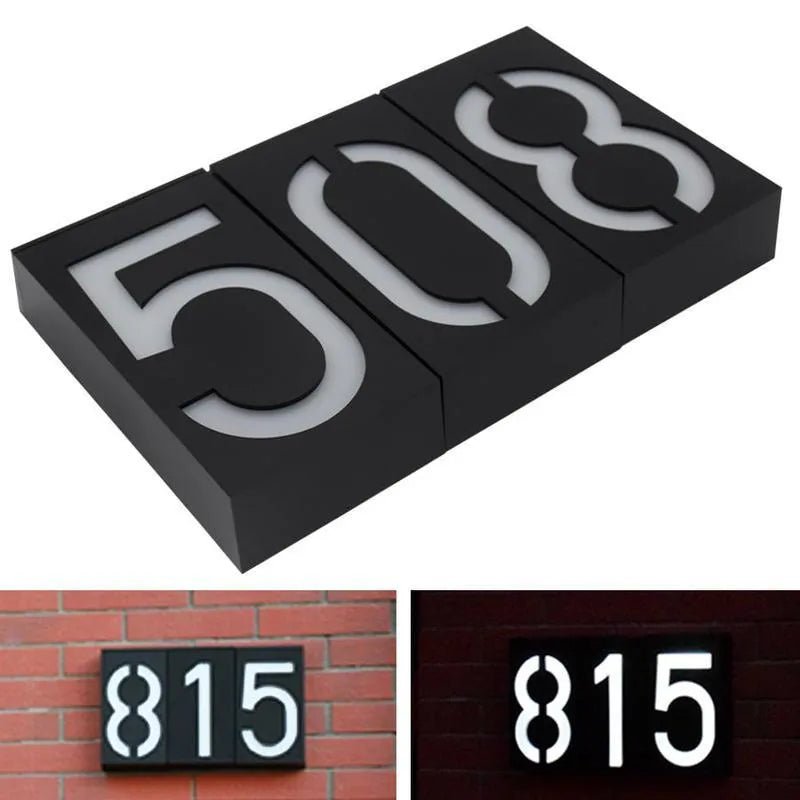 Solar powered house number light with LED illumination mounted on exterior wall