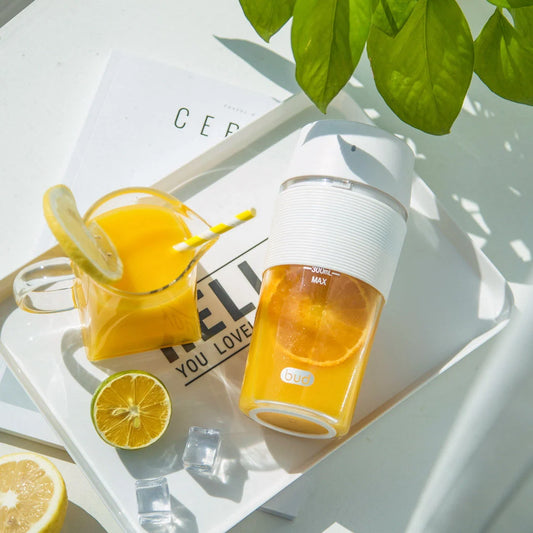 Wireless Charging Portable Mini Juicer Cup in pink and blue, compact and convenient for healthy juice on the go