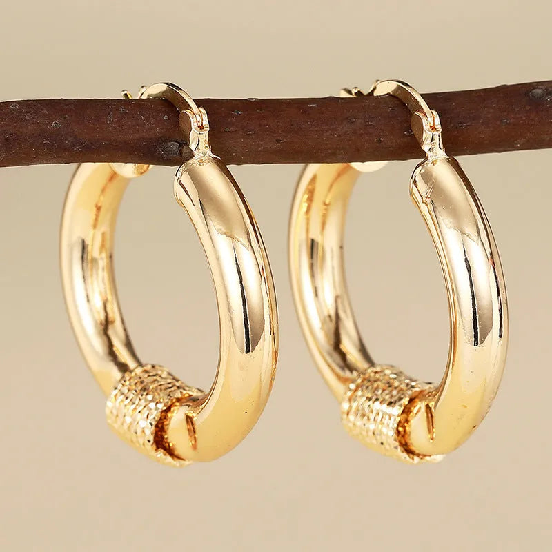 Geometric copper ring ear clip for women in a golden colour.