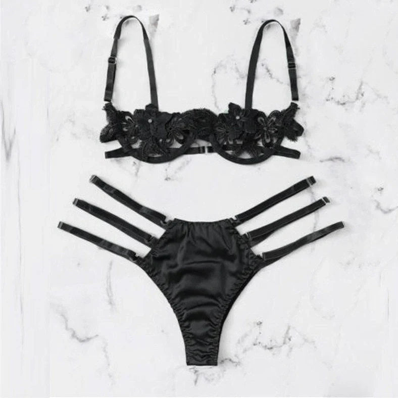 Women's black floral half-cup bra and brief set with fitted straps and back closure