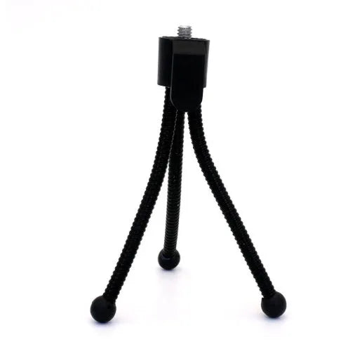 Compact silver metal mini tripod with ball head, shown folded next to an iPhone for scale.