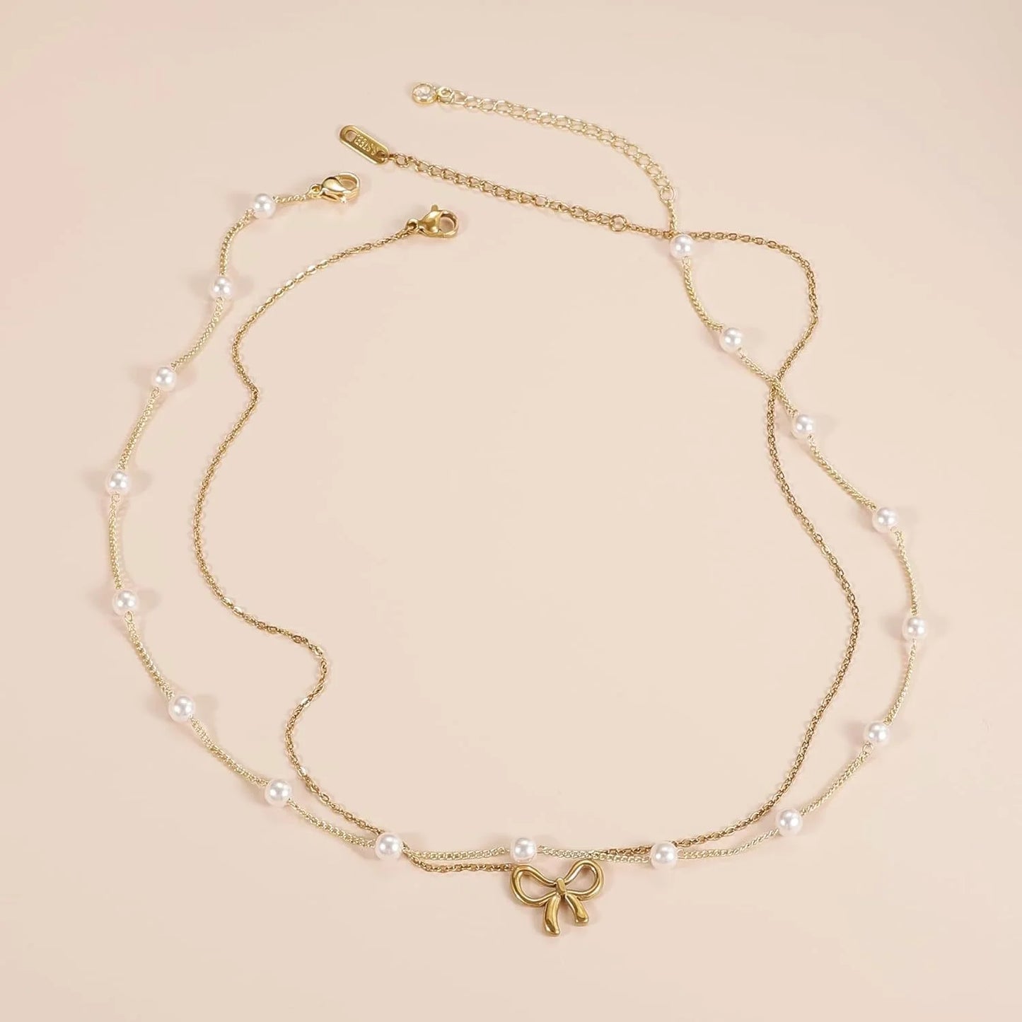 Double layer pearl choker with bow pendant in gold and silver options