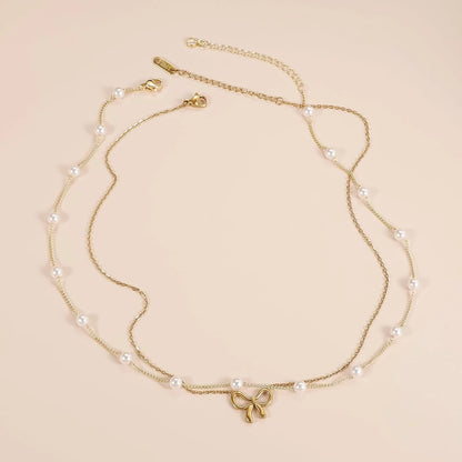 Double layer pearl choker with bow pendant in gold and silver options
