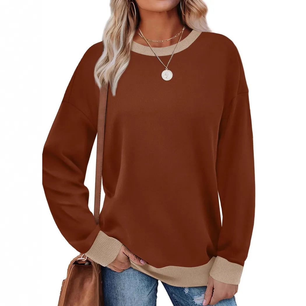 Women's loose round neck striped long sleeve top in apricot colour on a hanger.
