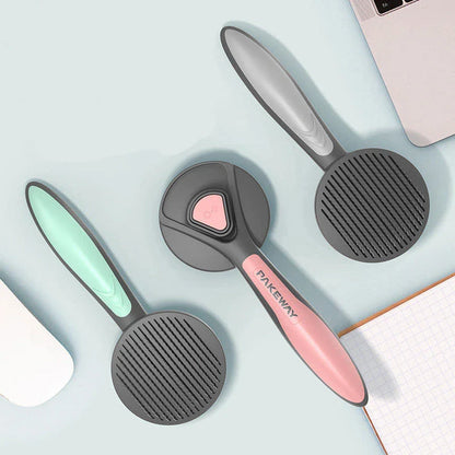 Ergonomic pet grooming brush in mint green, cherry blossom powder, and gentleman grey