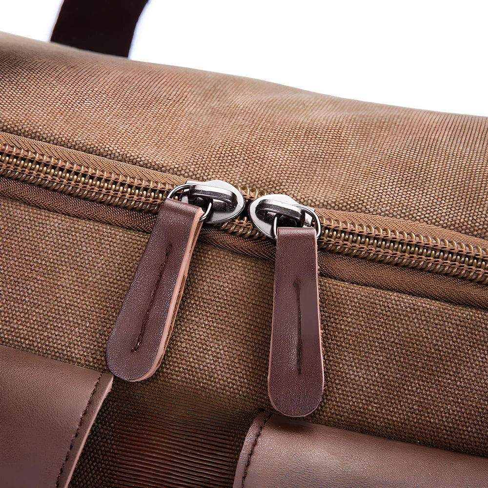 Medium canvas travel bag in black, 53x31x24cm with zipper top, double padded straps, waterproof canvas for 20-35L storage