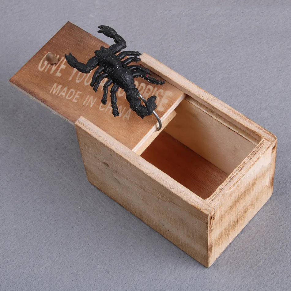 Wooden prank scare box closed on table, with random jumping animal surprise inside for April Fools' tricks.