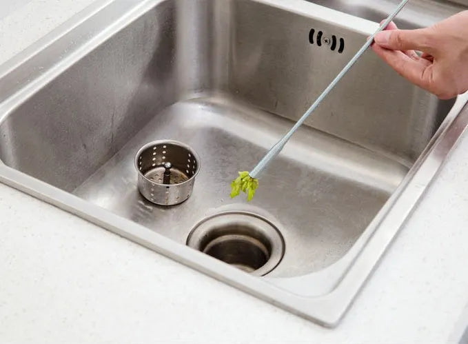 A black sewer dredge spring pipe cleaning tool for unblocking kitchen sink drains