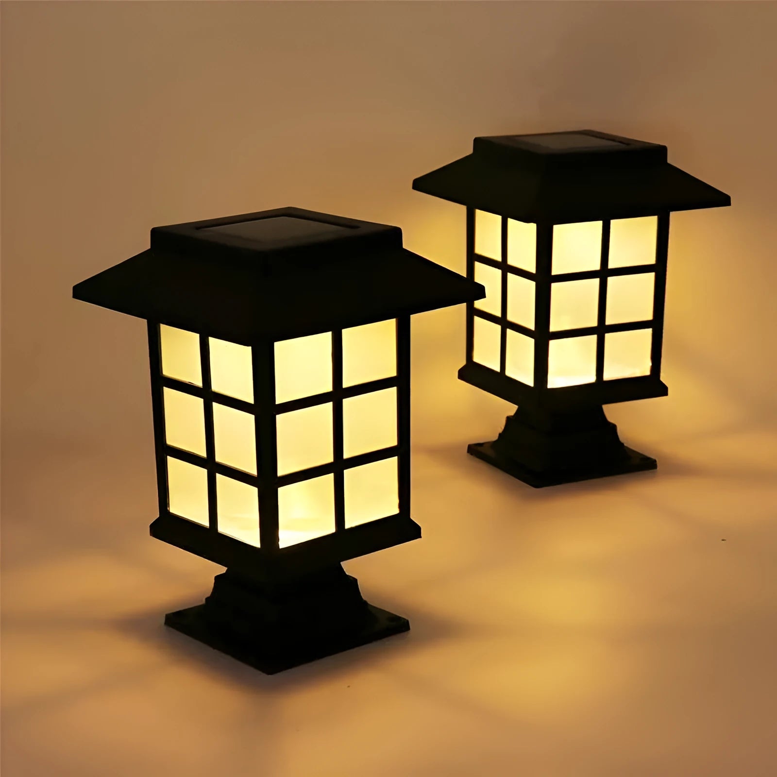 Black solar-powered outdoor LED lawn light with window-style openings, shown in a garden setting.