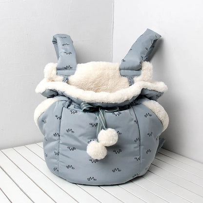 Winter travel pet chest backpack in blue and pink, designed for small pets